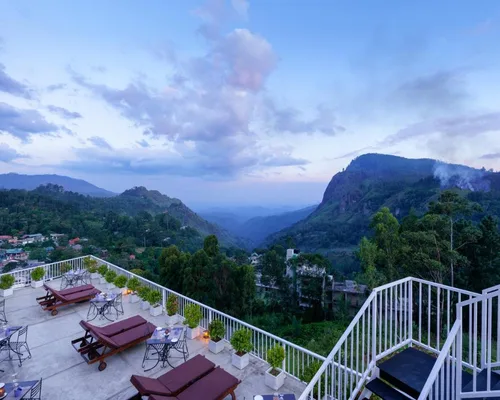 Terrace at Morning Dew Boutique Hotel overlooking Ella Gap at dusk